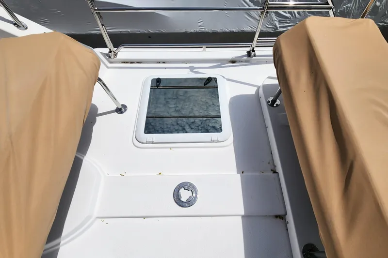 Slide: The Image of 2019 Ranger Tugs R-31 CB boat interior with beige covers and window view. - 36