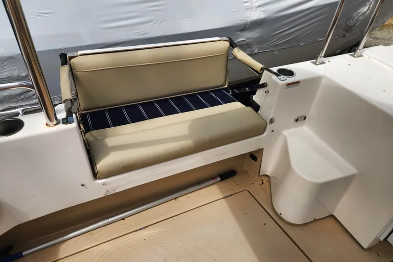 Slide: The Image of 2019 Ranger Tugs R-31 CB boat seating area with beige cushions and cup holders. - 39