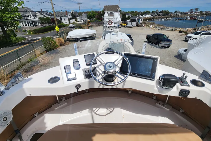 Slide: The Image of Cockpit view of 2019 Ranger Tugs R-31 CB boat with steering wheel and navigation equipment. - 40
