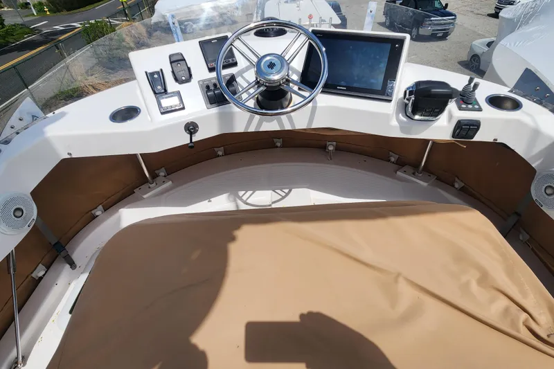 Slide: The Image of 2019 Ranger Tugs R-31 CB helm with steering wheel, controls, and navigation display. - 41