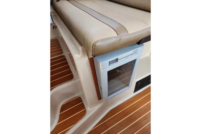 Slide: The Image of 2019 Ranger Tugs R-31 CB interior with cushioned seating and built-in mini fridge. - 43