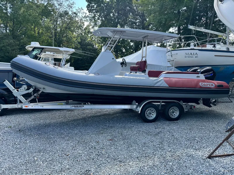 The Image of Apex A 24 boat from 2025 parked on a trailer outdoors. - 0