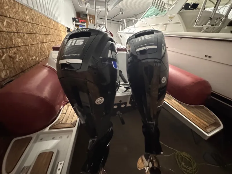 Slide: The Image of Two Mercury 115 outboard motors on an Apex A 24 boat, year 2025. - 11