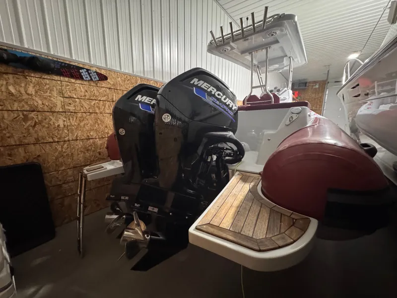 Slide: The Image of Apex A 24 boat with Mercury engines in a garage, year 2025. - 12