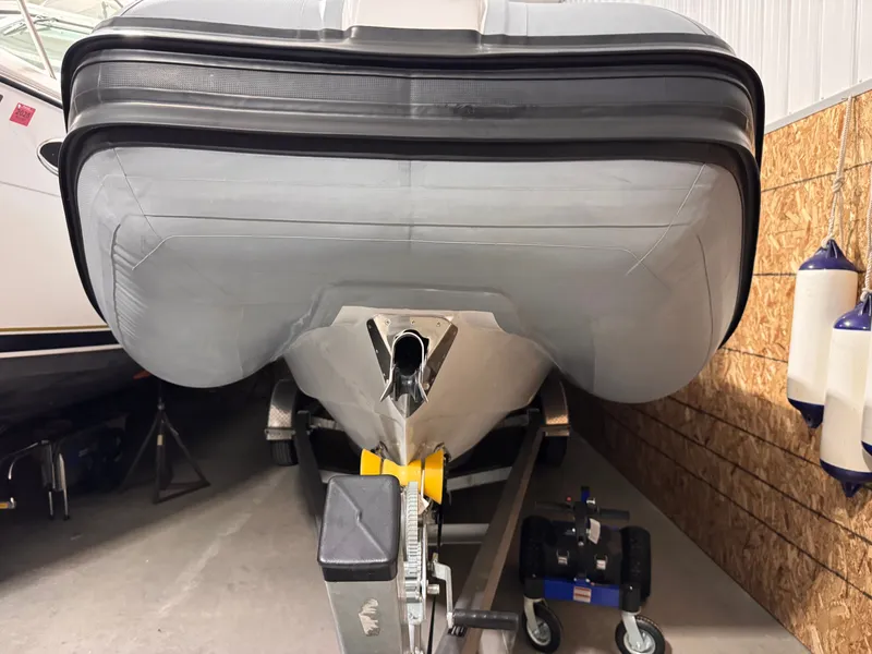 Slide: The Image of Apex A 24 boat from 2025 on a trailer in a garage. - 15