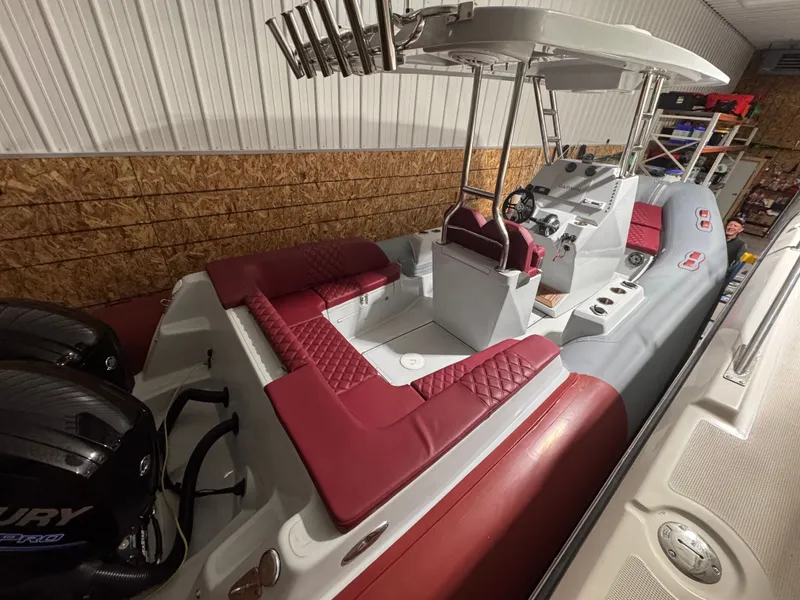 Slide: The Image of Apex A 24 boat 2025 with red seating and helm console. - 5