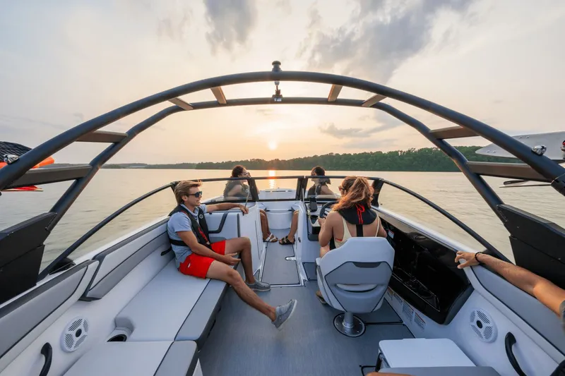 Slide: The Image of 2024 Yamaha AR220 boat cruising at sunset on the water. - 13