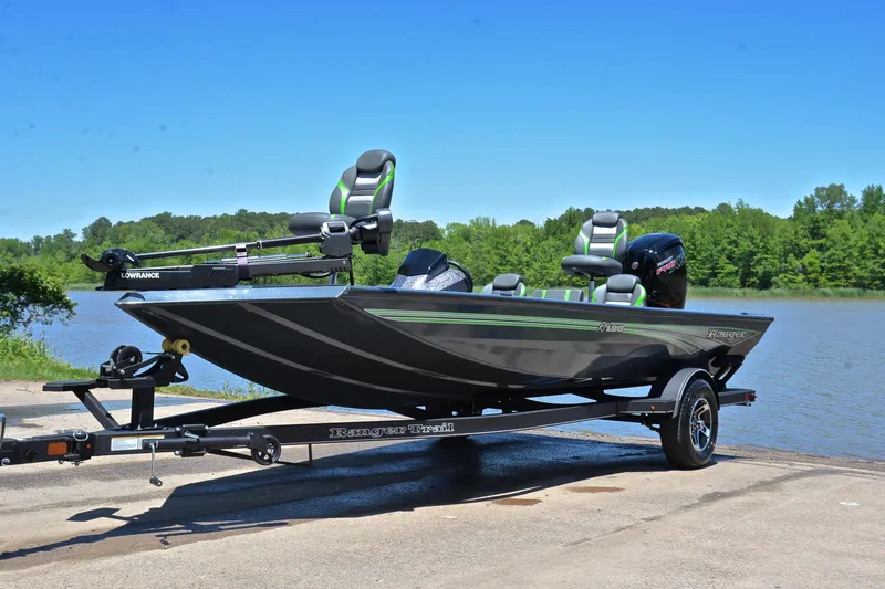 Slide: The Image of 2025 Ranger RT188 fishing boat on trailer by a lake, featuring sleek design and modern equipment. - 10