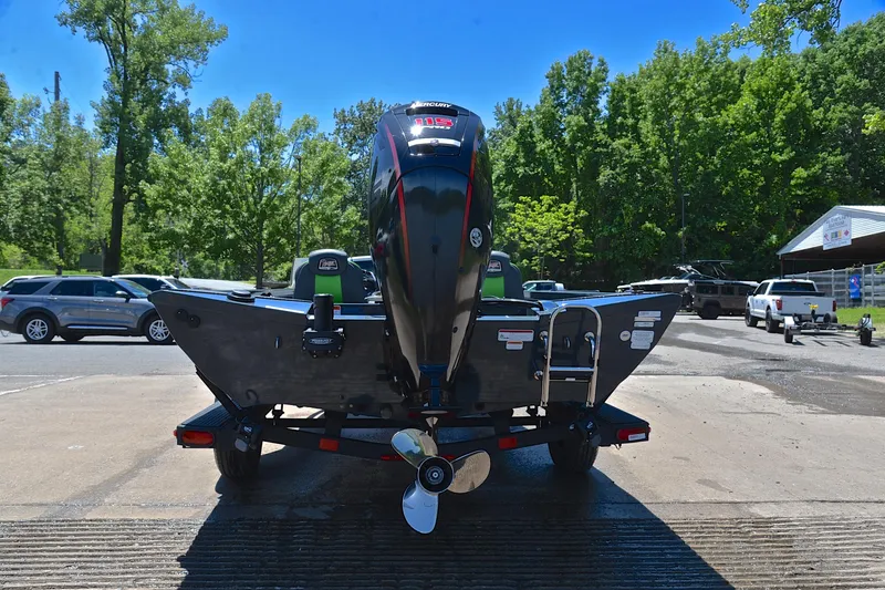 Slide: The Image of 2025 Ranger RT188 boat with outboard motor on trailer, surrounded by trees and parked cars. - 13