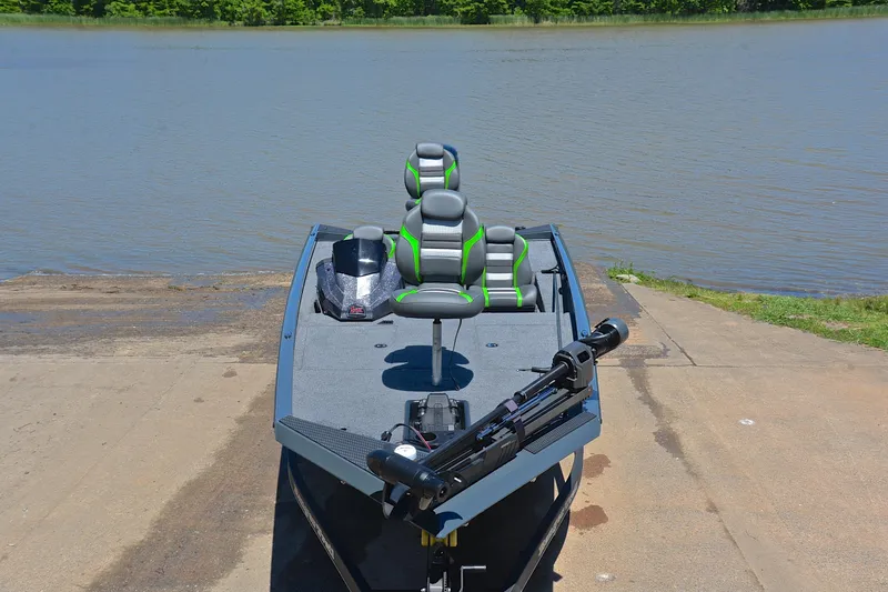Slide: The Image of 2025 Ranger RT188 boat at a lakeside ramp, featuring modern seating and equipment. - 17