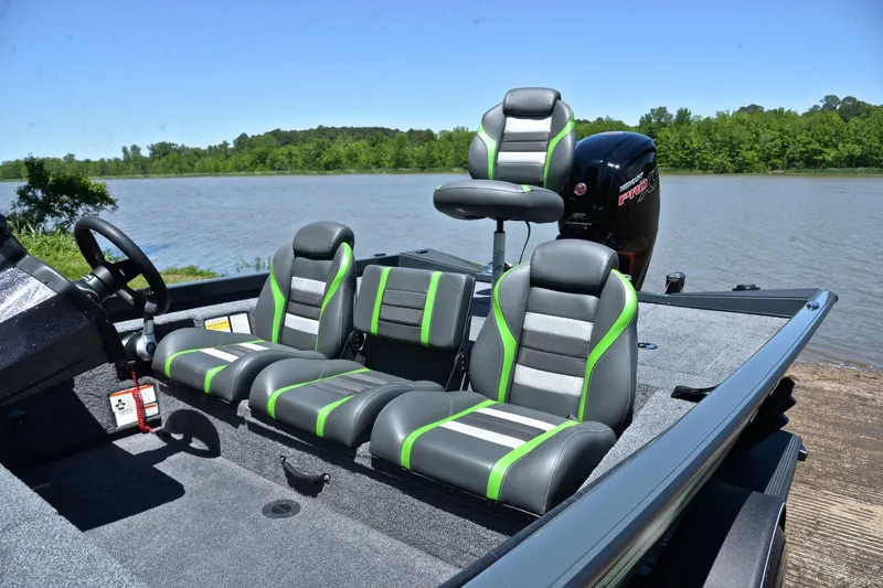 Slide: The Image of 2025 Ranger RT188 boat with green-accented seats by a serene lake. - 18
