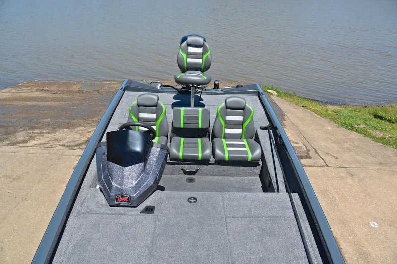 Slide: The Image of 2025 Ranger RT188 boat with green-accented seats, docked by a lake. - 23