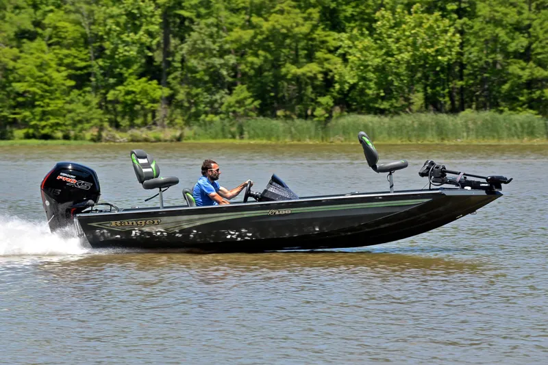 Slide: The Image of 2025 Ranger RT188 boat speeding on a lake with lush green trees in the background. - 3