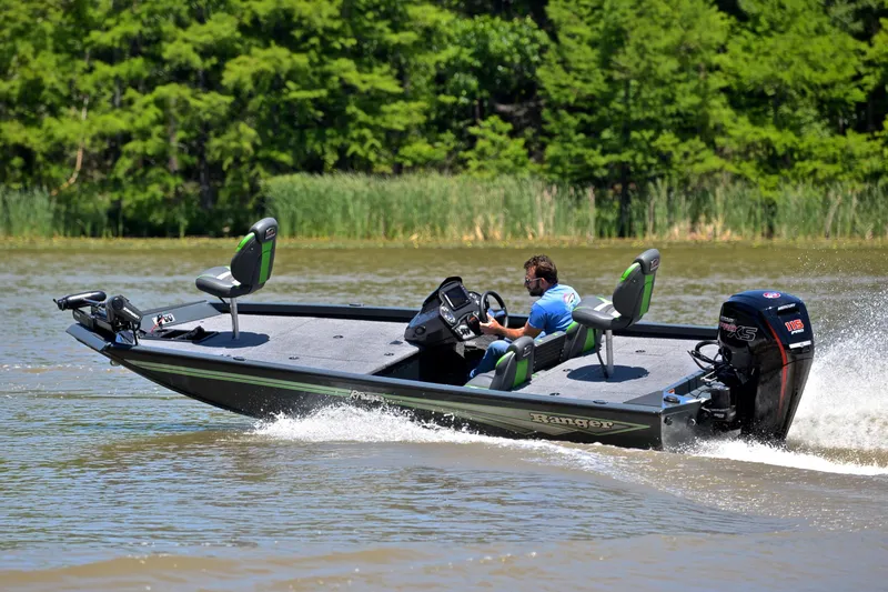 Slide: The Image of 2025 Ranger RT188 boat cruising on a lake with lush green trees in the background. - 5