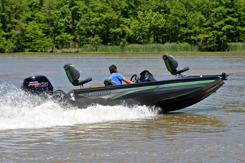 Slide: The Image of 2025 Ranger RT188 boat speeding on a lake with lush green trees in the background. - 6