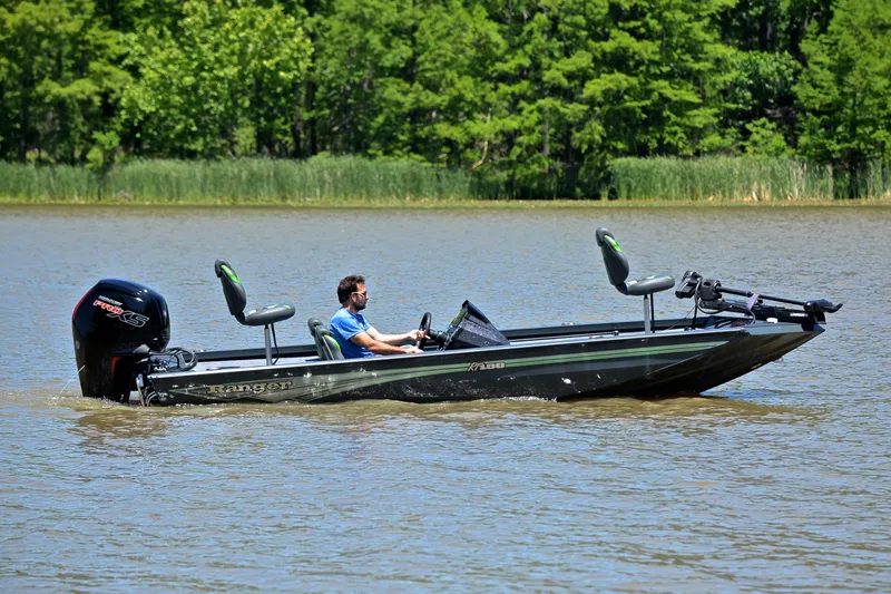 Slide: The Image of 2025 Ranger RT188 boat cruising on a lake with lush green trees in the background. - 7
