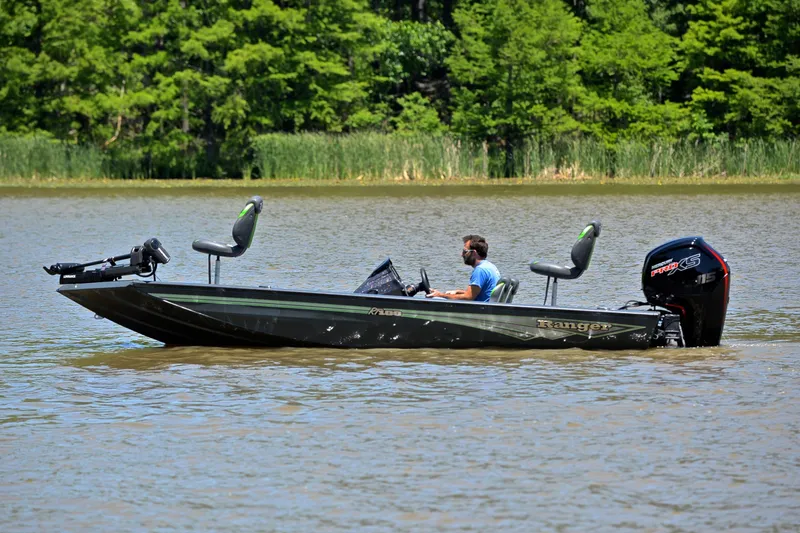 Slide: The Image of 2025 Ranger RT188 boat on a lake with lush green trees in the background. - 9