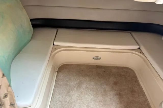 Slide: The Image of Interior seating area of 2001 Wellcraft 3300 Martinique boat, featuring cushioned seats and carpeted flooring. - 10