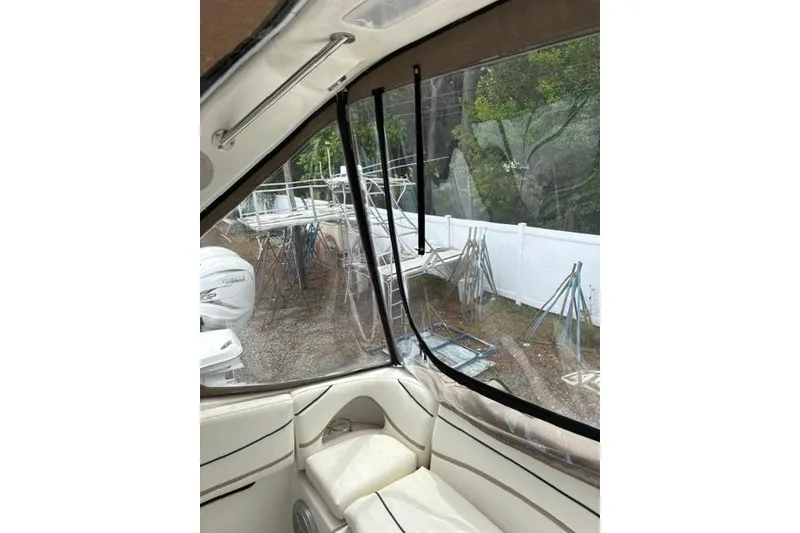 Slide: The Image of Interior view of a 2001 Wellcraft 3300 Martinique boat with clear enclosure panels. - 16