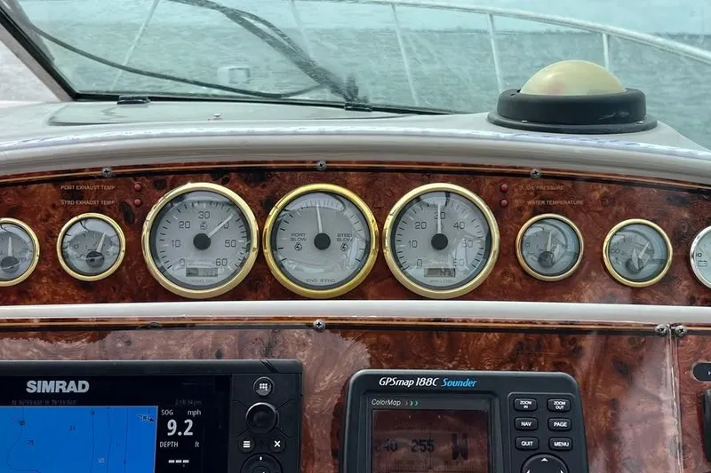 Slide: The Image of Dashboard of a 2001 Wellcraft 3300 Martinique boat with gauges and navigation equipment. - 18