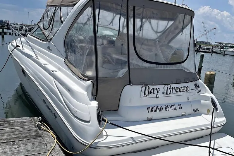 Slide: The Image of 2001 Wellcraft 3300 Martinique boat docked, named "Bay Breeze," in Virginia Beach marina. - 20