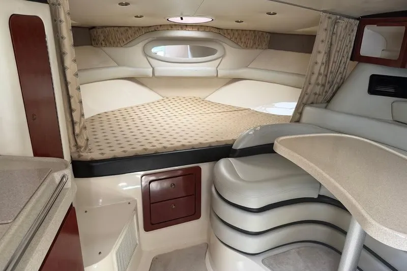 Slide: The Image of Interior cabin of 2001 Wellcraft 3300 Martinique boat, featuring a cozy sleeping area. - 21
