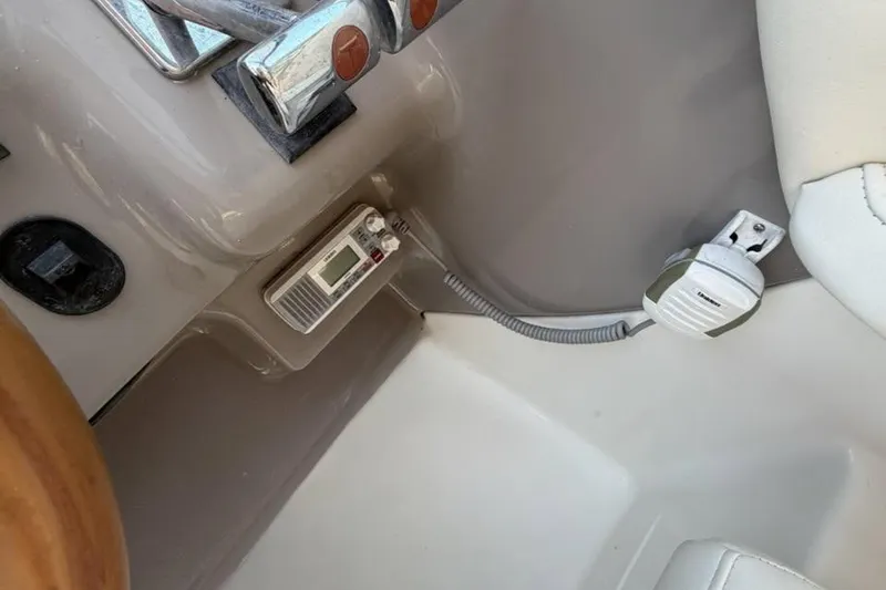Slide: The Image of Control panel of a 2001 Wellcraft 3300 Martinique boat, featuring throttle and communication devices. - 22