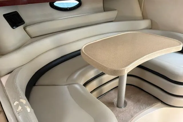 Slide: The Image of 2001 Wellcraft 3300 Martinique interior with beige seating and table. - 8