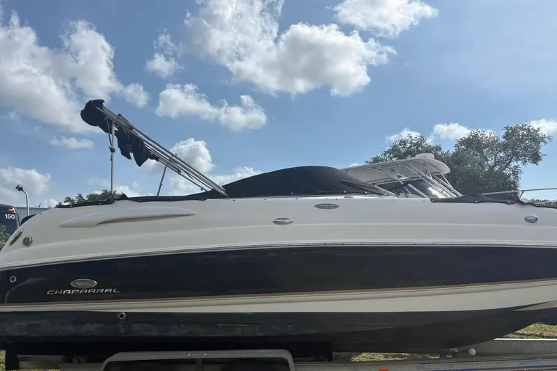 The Image of 2006 Chaparral Sunesta 236 boat on trailer under blue sky with clouds. - 0