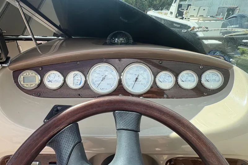 Slide: The Image of Dashboard of a 2006 Chaparral Sunesta 236 boat with gauges and steering wheel. - 12