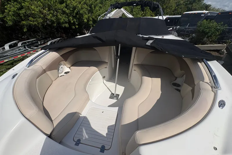 Slide: The Image of 2006 Chaparral Sunesta 236 boat interior with beige seating and black cover. - 19