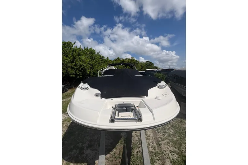 Slide: The Image of 2006 Chaparral Sunesta 236 boat on trailer under blue sky. - 4