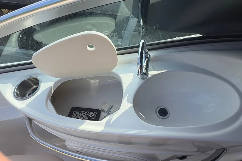 Slide: The Image of 2006 Chaparral Sunesta 236 boat sink with faucet and storage compartment. - 6