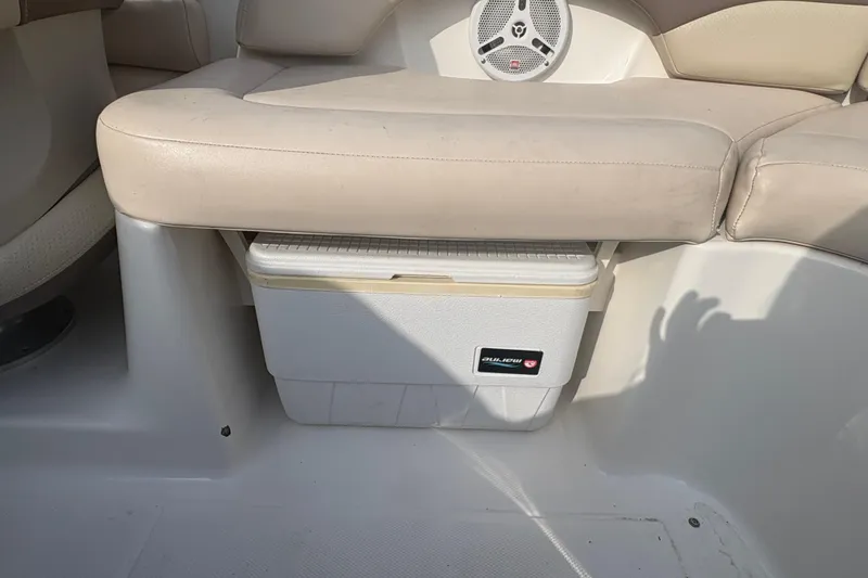 Slide: The Image of 2006 Chaparral Sunesta 236 boat interior with beige seating and built-in cooler. - 7