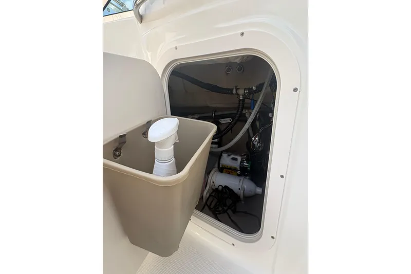 Slide: The Image of Storage compartment in 2006 Chaparral Sunesta 236 boat with cleaning supplies. - 9