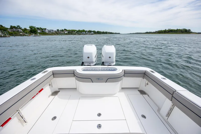 Slide: The Image of 2022 Valhalla Boatworks V-33 on calm water, featuring dual engines and spacious deck. - 13