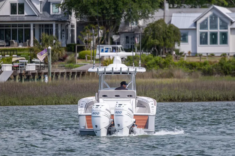 Slide: The Image of 2022 Valhalla Boatworks V-33 cruising near waterfront homes. - 2