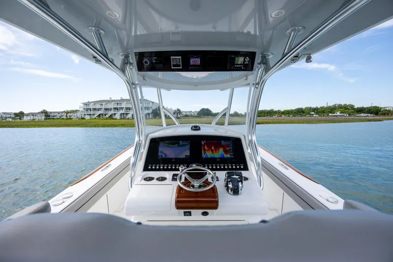 Slide: The Image of 2022 Valhalla Boatworks V-33 helm with advanced navigation system on calm waters. - 21