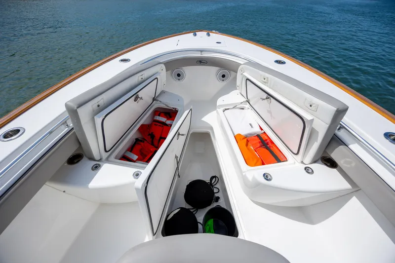 Slide: The Image of 2022 Valhalla Boatworks V-33 deck with open storage compartments and life jackets. - 35