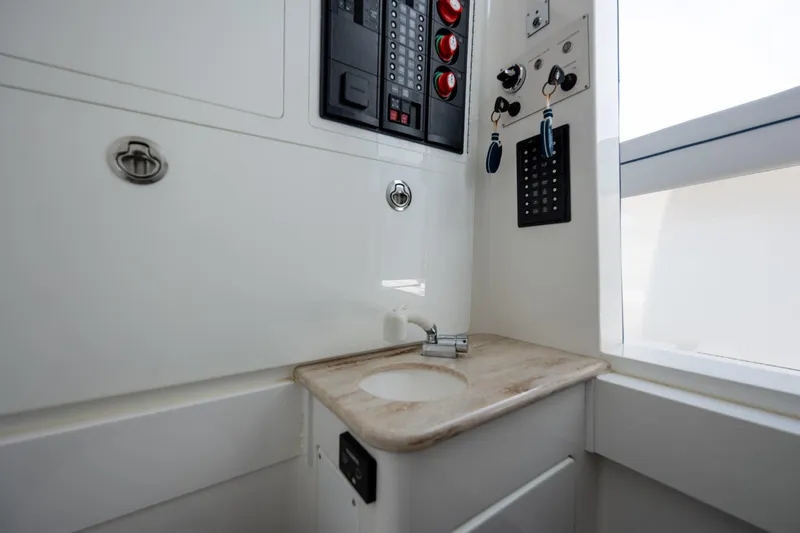 Slide: The Image of Interior of 2022 Valhalla Boatworks V-33 featuring control panel and compact sink area. - 37