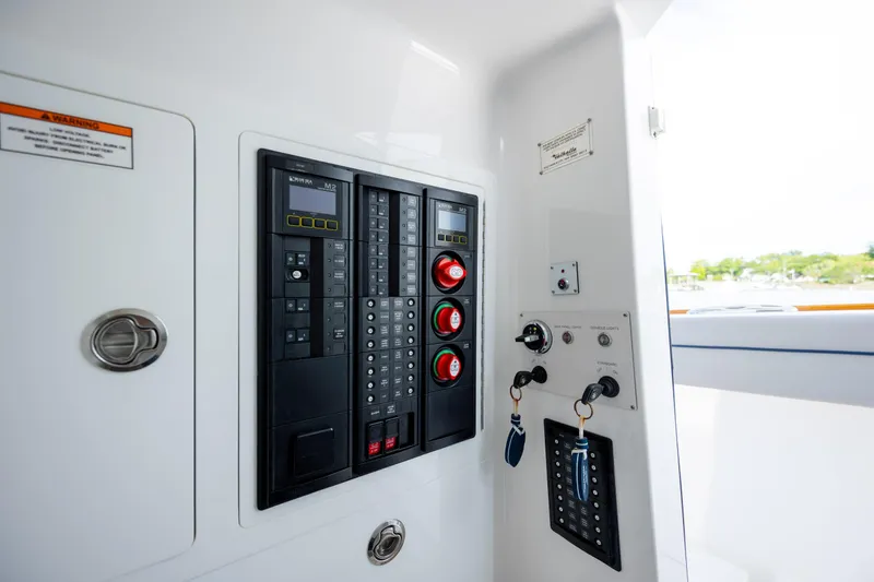 Slide: The Image of Control panel of 2022 Valhalla Boatworks V-33, featuring switches and keys in a sleek design. - 38