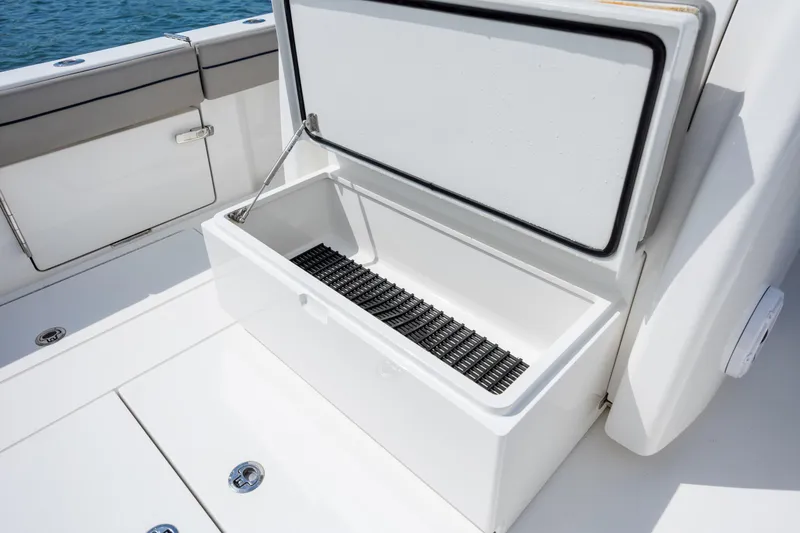Slide: The Image of 2022 Valhalla Boatworks V-33 open storage compartment on deck, near ocean. - 46