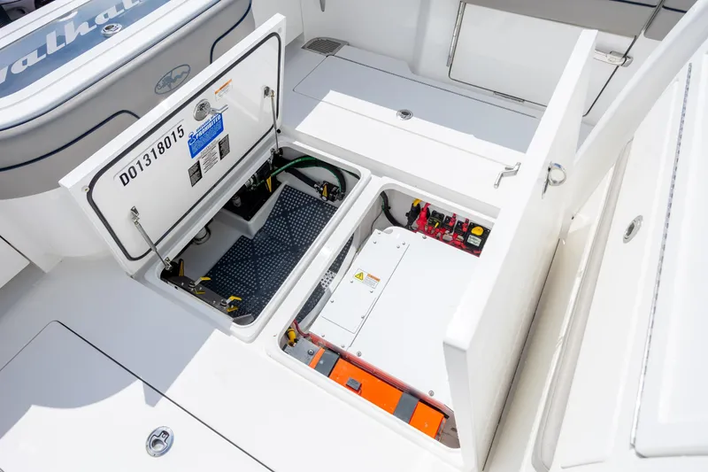 Slide: The Image of 2022 Valhalla Boatworks V-33 open hatch showing electrical components and storage area. - 47