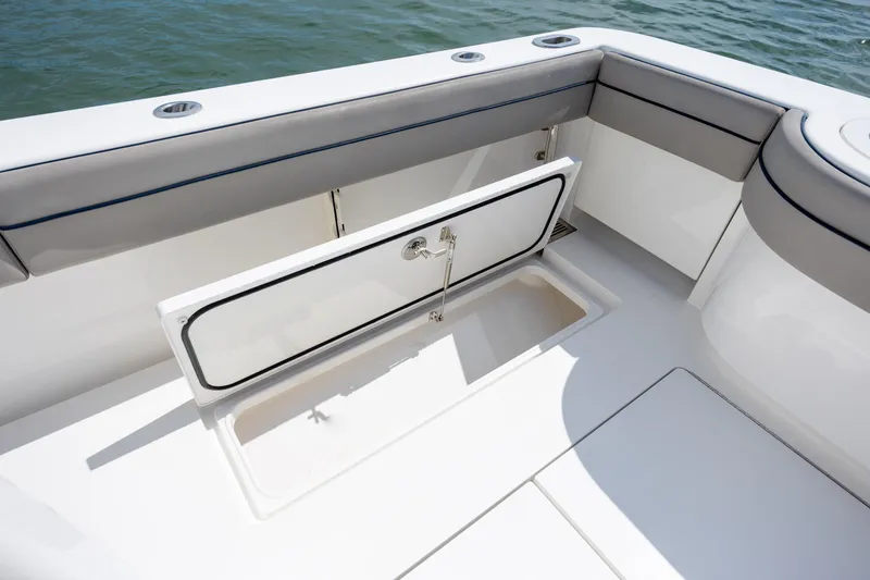 Slide: The Image of 2022 Valhalla Boatworks V-33 interior storage compartment with open hatch, near water. - 52