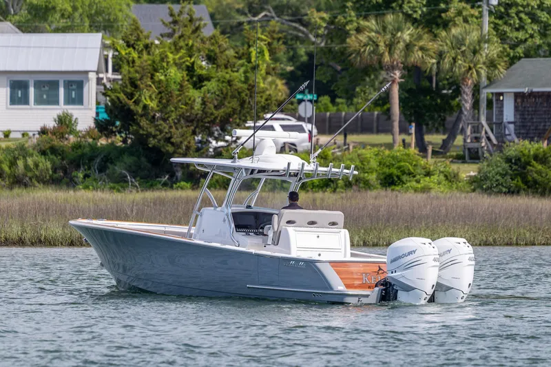Slide: The Image of 2022 Valhalla Boatworks V-33 cruising on a scenic waterway with twin Mercury engines. - 8