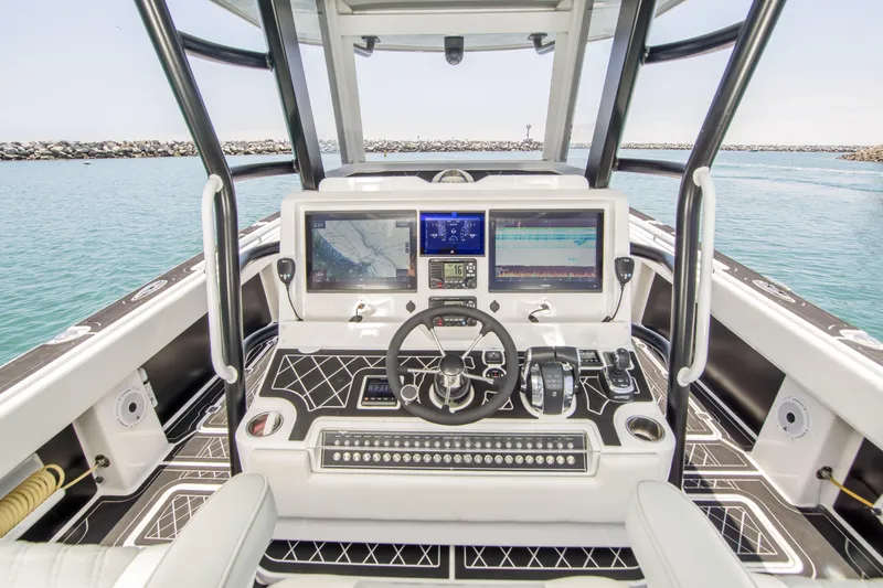 Slide: The Image of Invincible 35 Catamaran 2021 helm station on open water. - 11