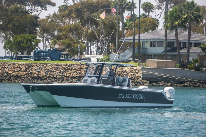 Slide: The Image of Invincible 35 Catamaran 2021 on water, featuring "It's All Good" lettering. - 2