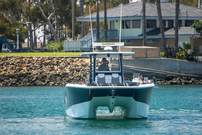 Slide: The Image of Invincible 35 Catamaran 2021 on water near coastline. - 4