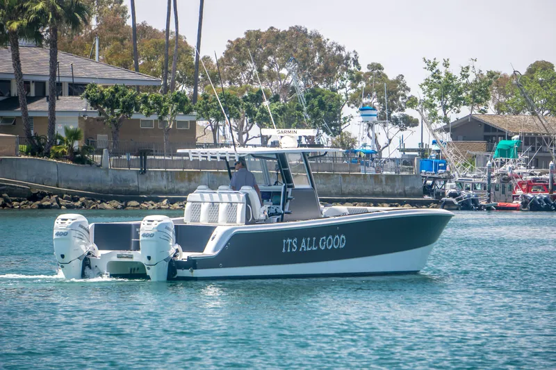 Slide: The Image of Invincible 35 Catamaran 2021 on water, featuring "It's All Good" lettering. - 6