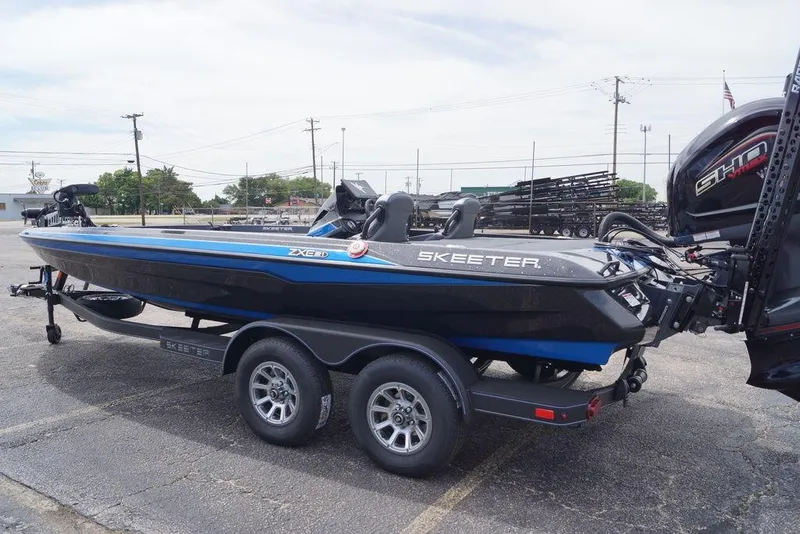 Slide: The Image of 2026 Skeeter ZXE21 boat on trailer, parked outdoors, showcasing sleek design and modern features. - 13
